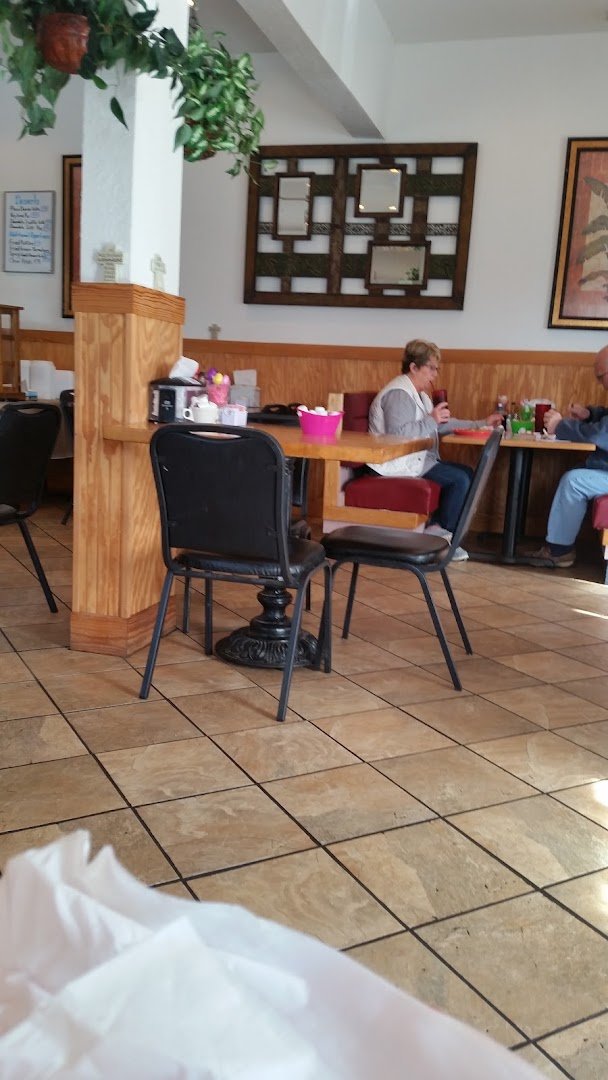 Family restaurant dining room with tables and chairs.