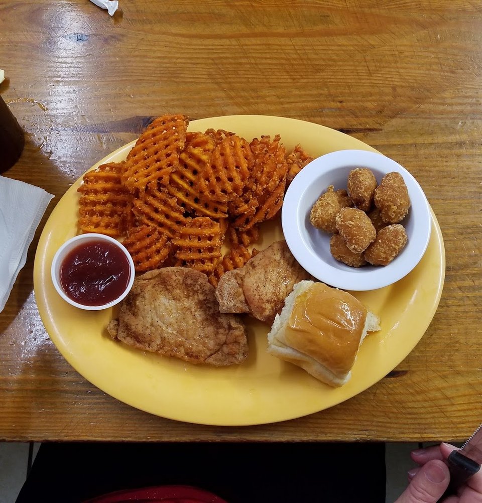 Comfort food plate with fried catfish and sides.